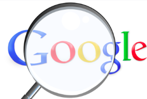 The Google Logo with a magnifying glass overlaying the logo